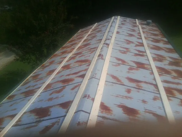 Rusted metal roof panels with new wood purlins before replacement — Storm Damage Roof Repair in Tempe by Roofing Brothers