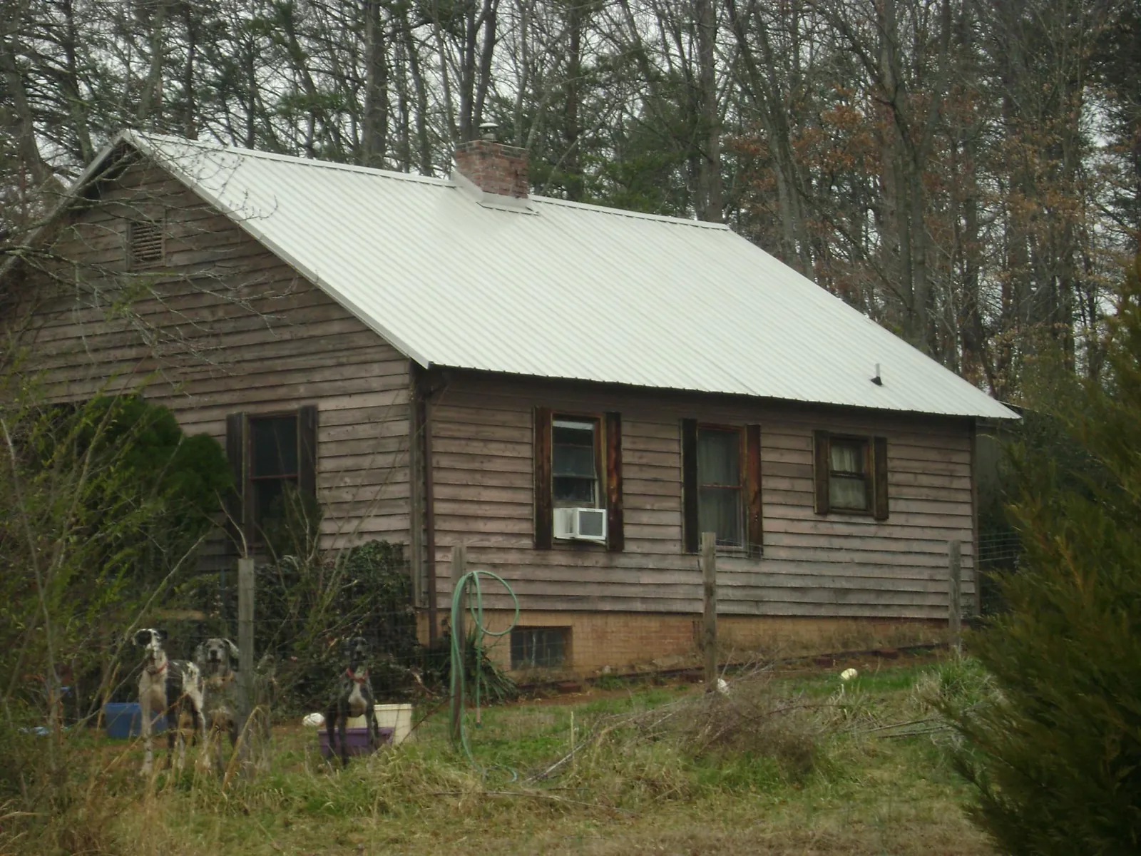 White metal roof on an old wood sided farmhouse, from a Metal Roof Installation job in Tempe